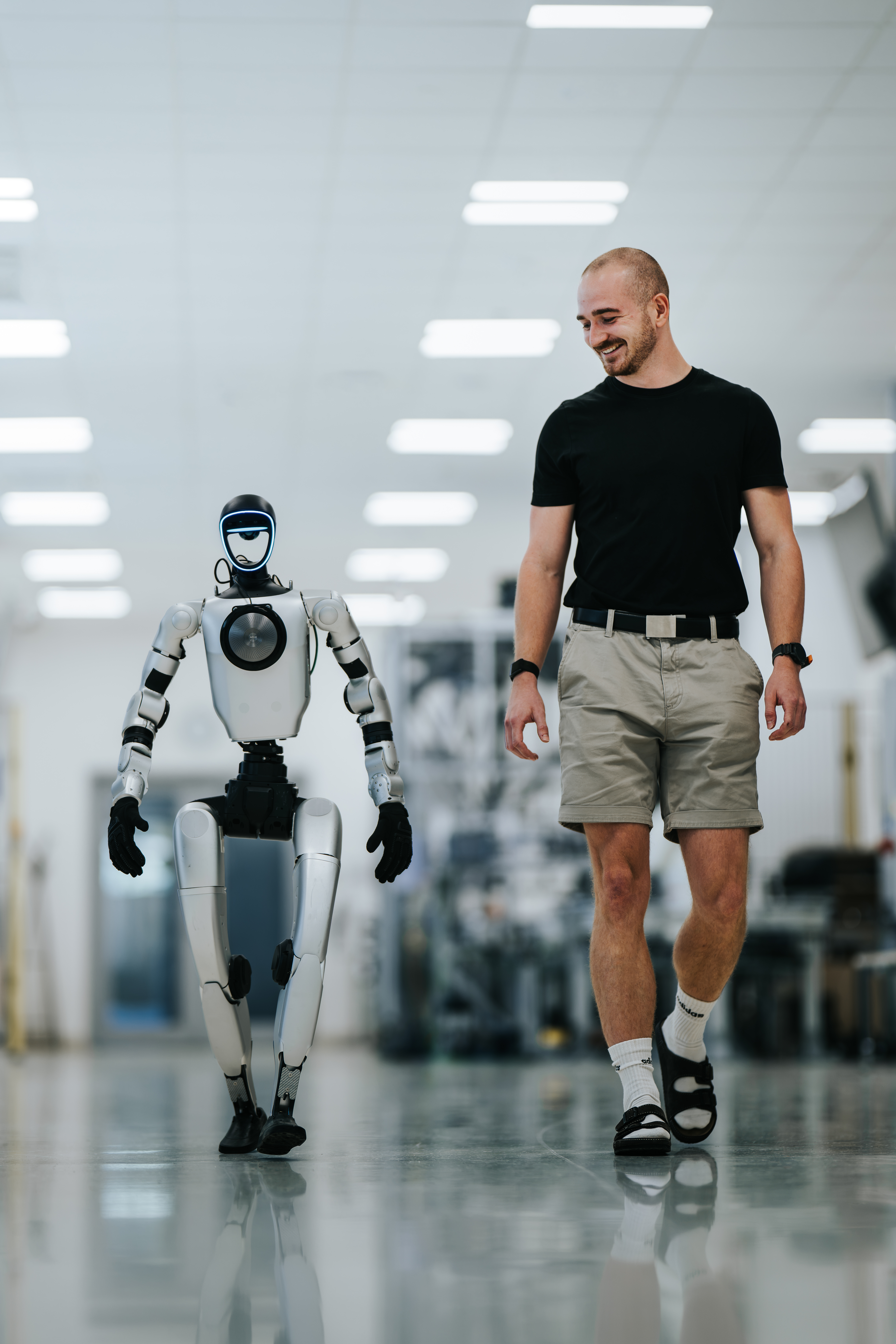 Lukas Navara walking alongside the Unitree G1 humanoid robot